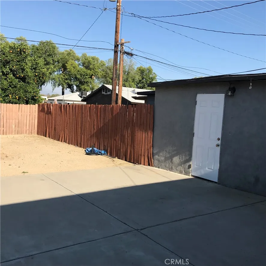 The fence that separates the area behind the garage.
