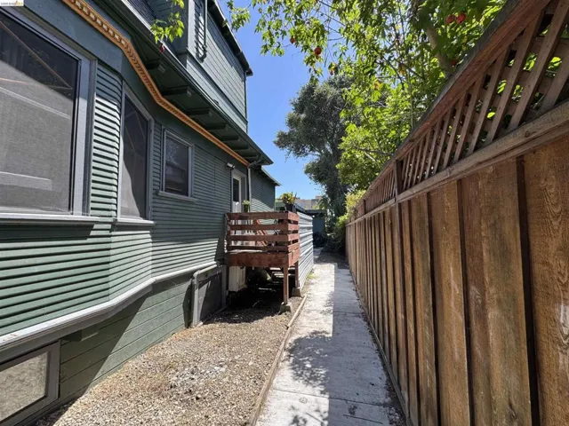Exterior featuring horizontal siding, decorative trim, bay window, and a wooden deck