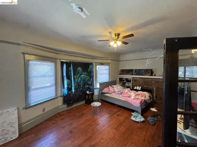 Room featuring hardwood flooring and a ceiling fan