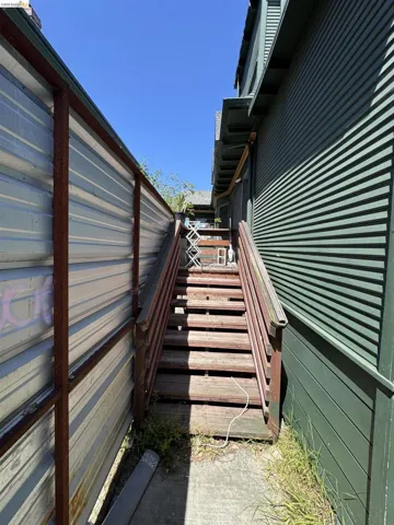 Exterior wooden staircase leading to an upper level