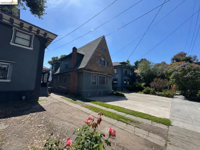 Traditional exterior architecture featuring a prominent gabled roof with shingle siding