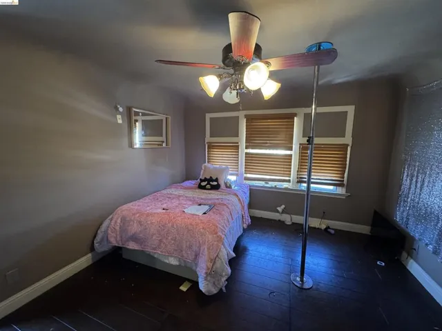 Room featuring dark wood-finish flooring and neutral wall tones