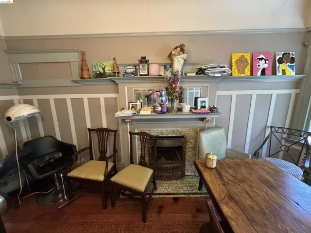 Traditional fireplace with a decorative mantel, brick-style surround, and cast iron firebox