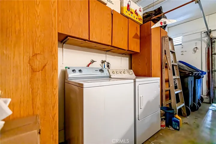 Attached garage featuring built-in cabinetry and laundry area