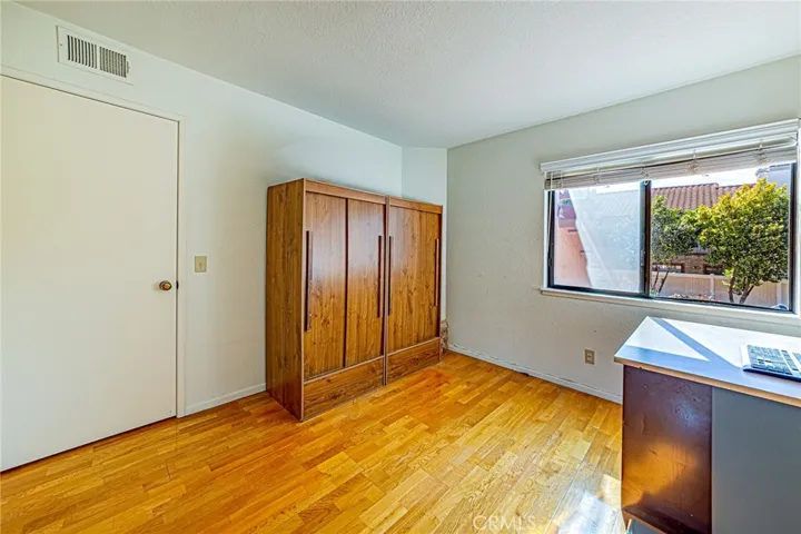Bright third bedroom featuring window and view of the neighborhood