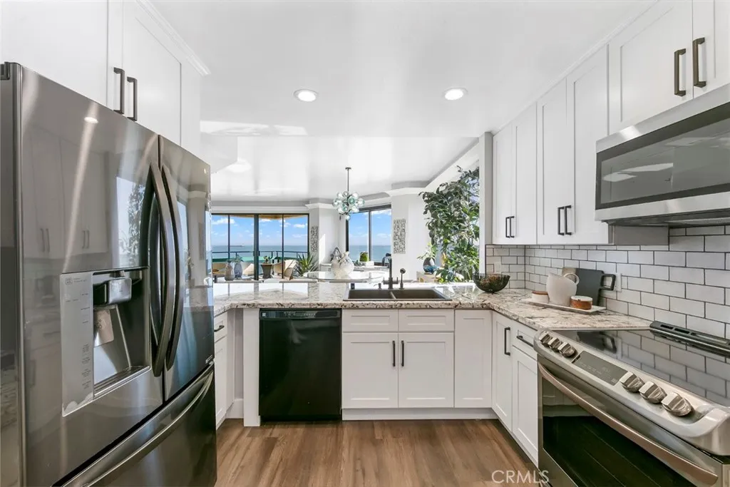 Custom kitchen with custom made cabinetry all with views panoramic of the Pacific Ocean.