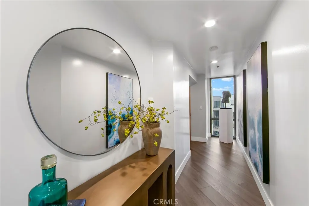 Enter from the left to elegant formal entry Hall that services all the rooms of the property. As u enter and turn to your left is window view toward Newport as you turn right takes you to the FLEX room secondary bathroom, kitchen, primary bedroom, main living space and private ocean view balcony.