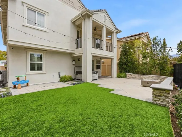 Large yard with artificial turf and professionally designed