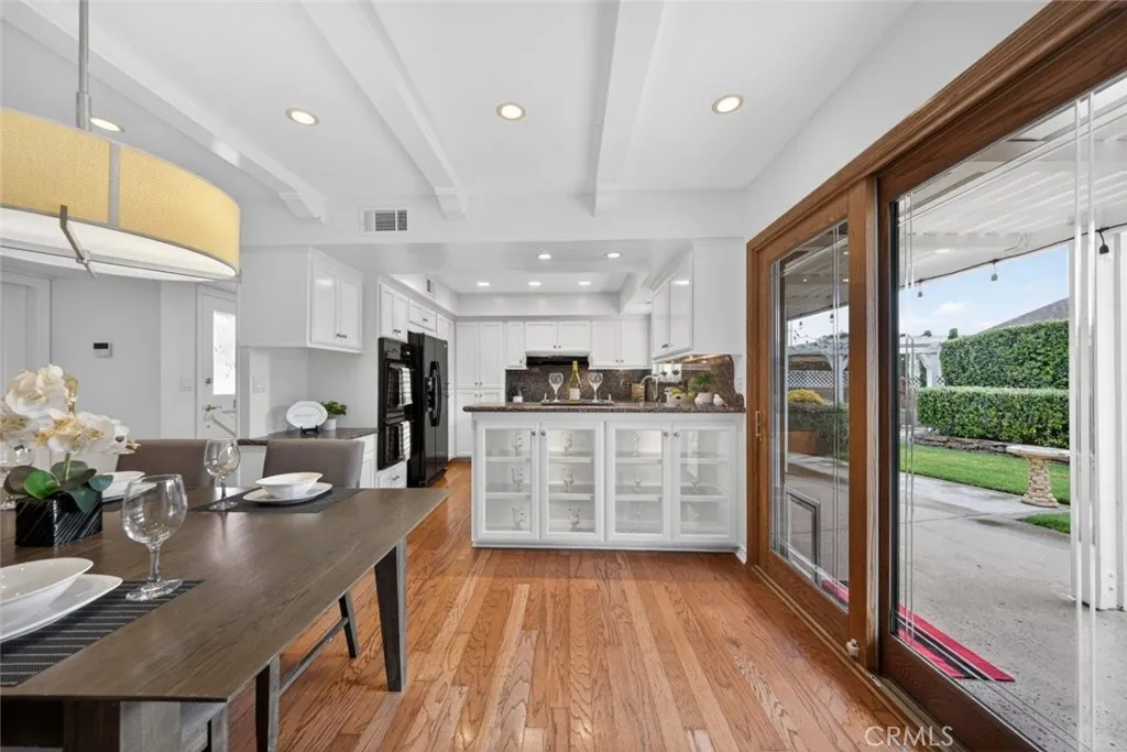 A wonderful Dining Room, and Kitchen view of the amazing lush green backyard and patio.