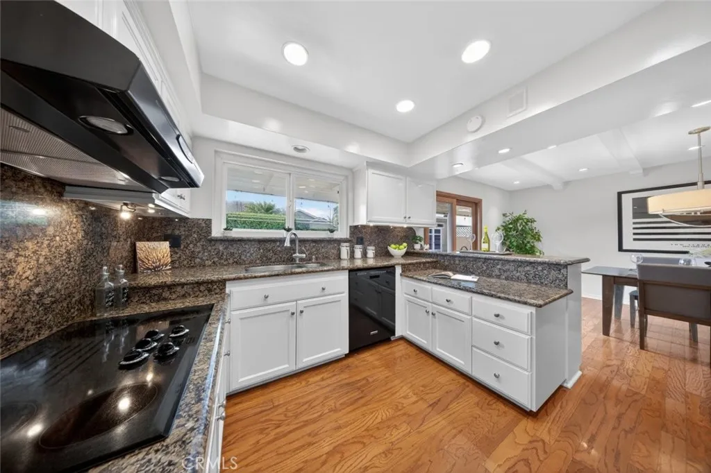 Lovely Kitchen and space which opens to the Dining Room with sliding doors leading to the outdoor patio and lush grass area.
