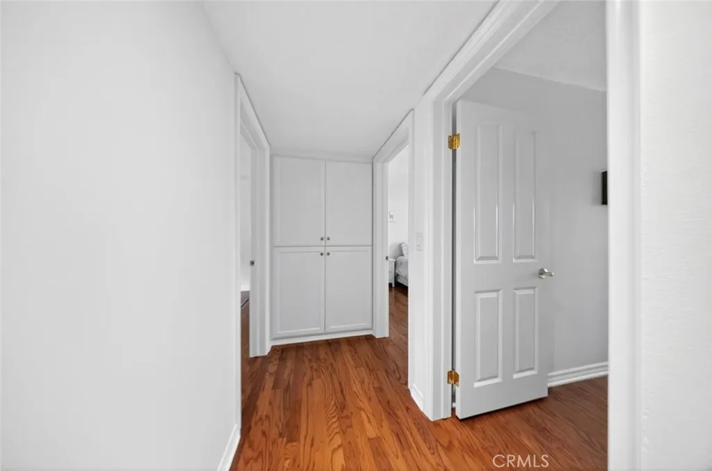 Hallway with linen storage.