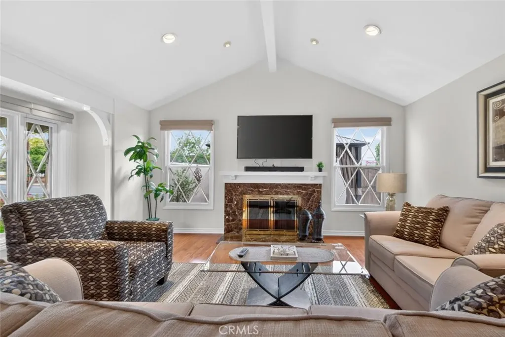 Living Room with a view of the lush green colorful front yard.