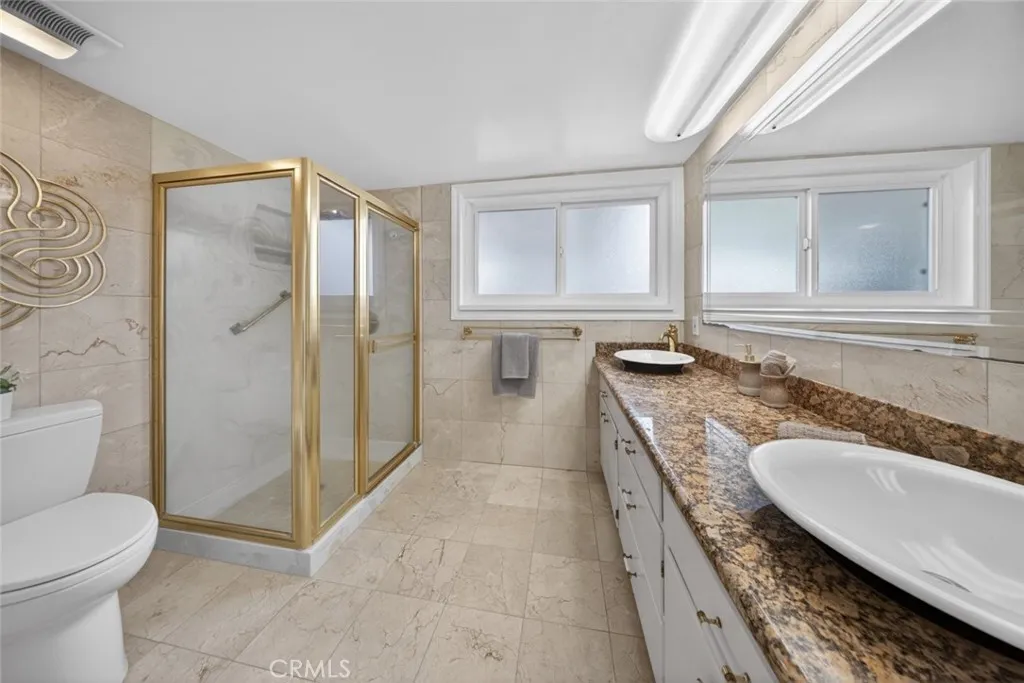 Primary Bath with walk in shower and dual sinks.
