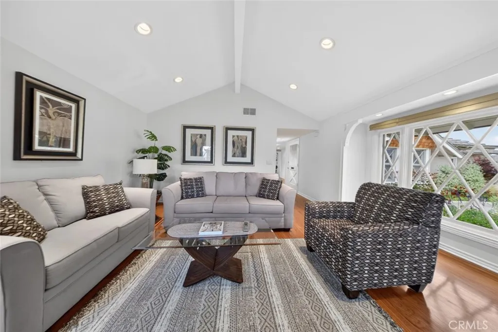 All new fresh interior paint and recessed lighting with a view of the lush green and colorful front yard.