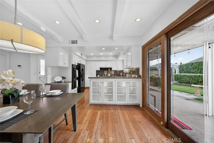 A wonderful Dining Room, and Kitchen view of the amazing lush green backyard and patio.