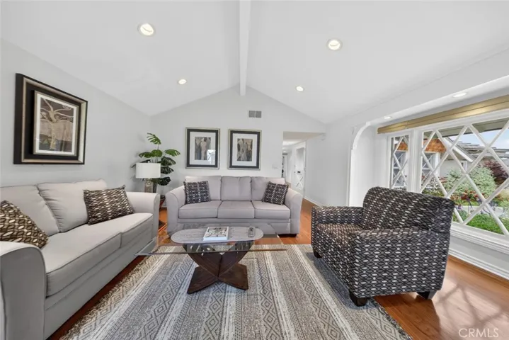 All new fresh interior paint and recessed lighting with a view of the lush green and colorful front yard.