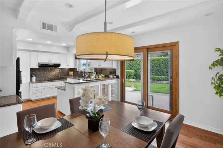 A cozy Dining Room with sliding wood door leading to the outdoor patio area.