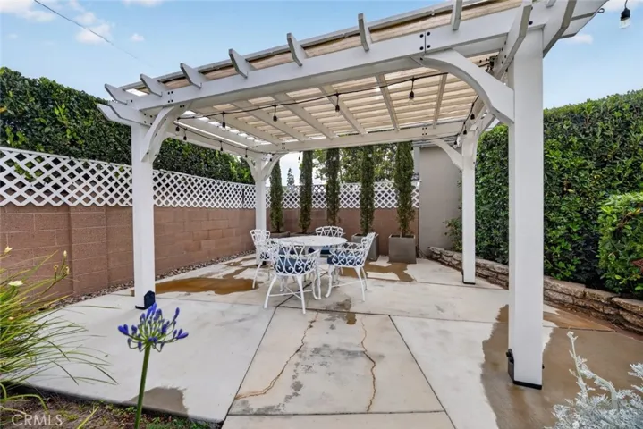 Enjoy a cold glass of lemonade while sitting on your peaceful patio surrounded by lush landscaping and gazebo lights.