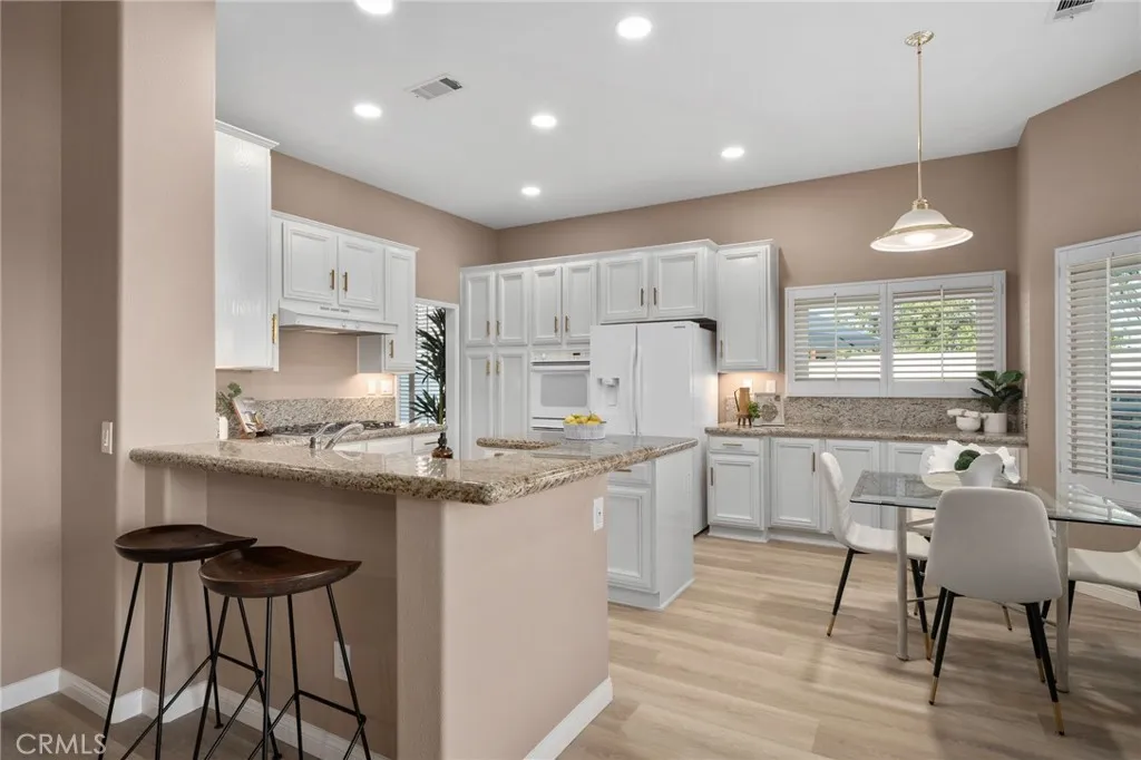 kitchen with breakfast bar and included fridge