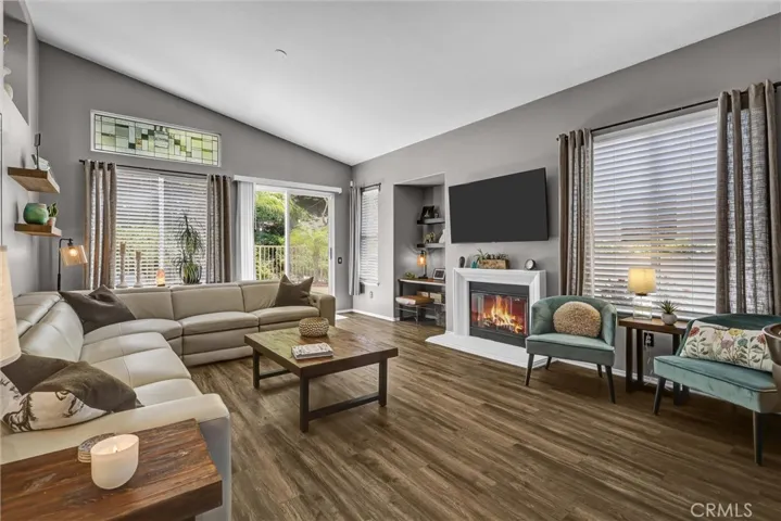 Spacious Family Room offering a cozy Re-faced fireplace with gas logs, built in desk area