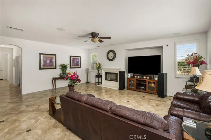 Another angle of Family Room with Hallway to Downstairs Bedroom, Full Bathroom, Laundry Room, & 1-Car Garage.