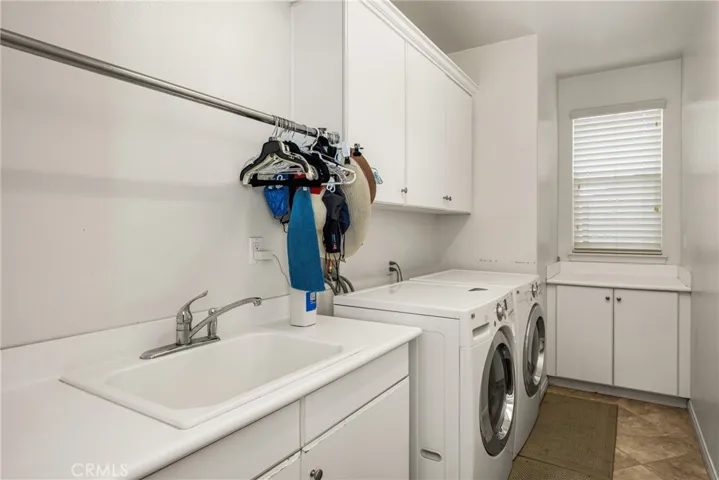 Downstairs Laundry Room with Sink & Storage.