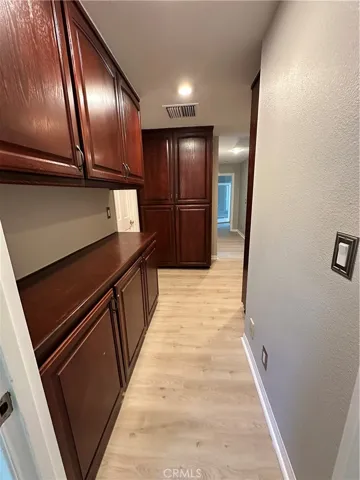 west side hall with lots of cabinets