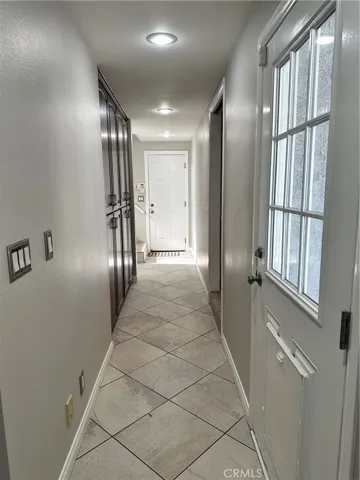 East side hall with access to backyard, garage, kitchen, pantry, bonus room, one full bath and 2 bedrooms.