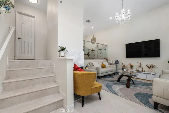 Living room and entry stair up to kitchen and dining