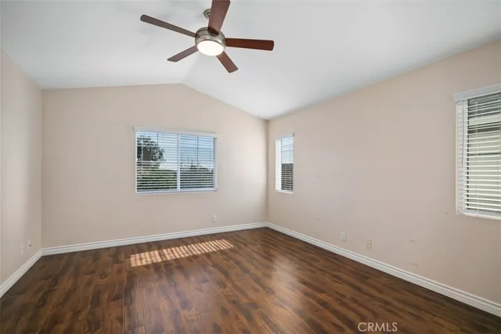 Here is a view of the primary bedroom complete with a ceiling fan