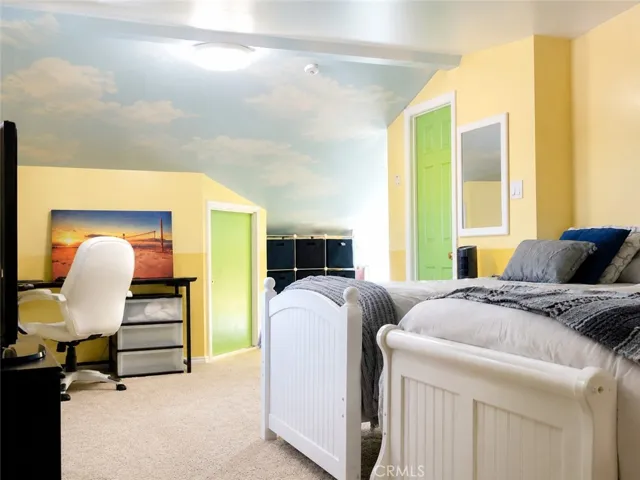 Extra bedroom upstairs with window and walk-in closet and extra storage.