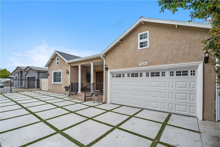 Decorative driveway with two-car attached garage with direct access to home.  Tesla charger installed.
