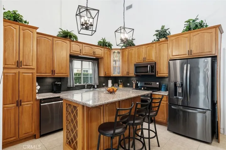 Newer black stainless steel appliances and gas range. Kitchen island with additional storage.