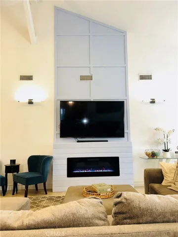 Modern built-in electric fireplace with ambient lighting.