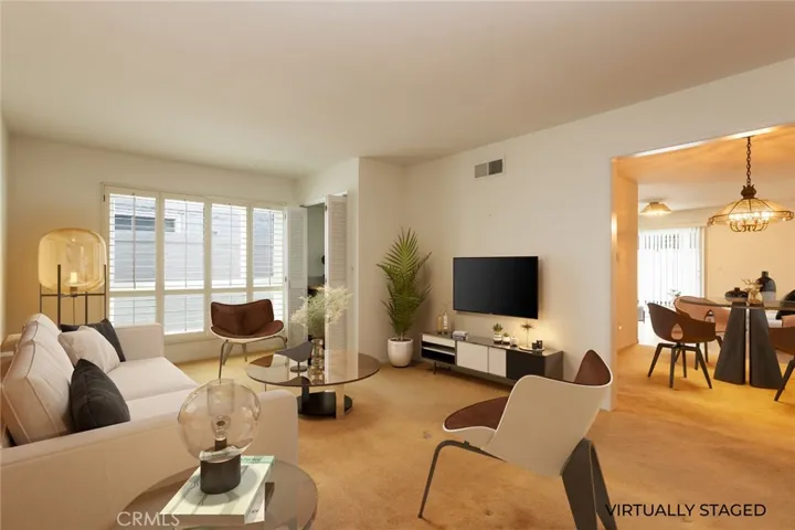VIRTUALLY STAGED formal living room looking into dining room