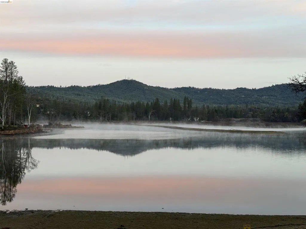 Expansive waterfront with tranquil, reflective waters and a natural shoreline