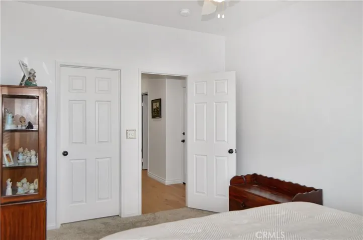 The 4th Bedroom is on the Main Floor Near the 3rd Full Bath and was a Builder Option for this Plan. It Offers Plush Carpeting, a Ceiling Fan, and a Walk-in Closet.