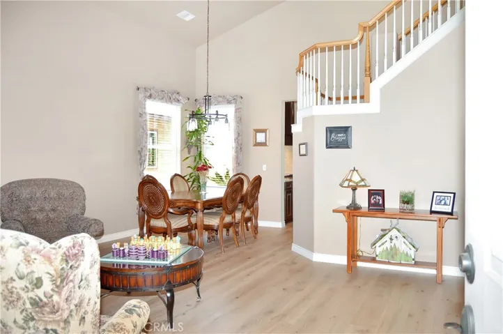 Come on in! New engineered hardwood flooring adorns most of the main level. The living and dining room have double-height ceilings and the spiral staircase adds a dramatic flair.