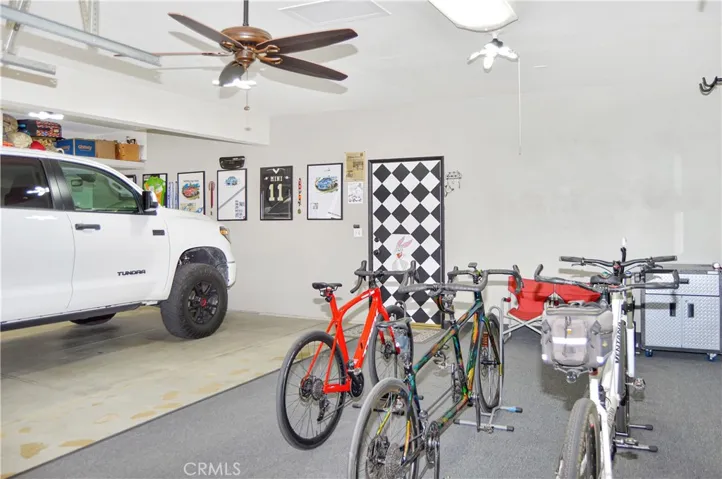 The Spacious 3-Car Garage Offers Newer Premium Shaft Drive LiftMaster Garage Door Openers, a Ceiling Fan, Overhead Storage and a Door to the Backyard Close to the Bonus Workshop