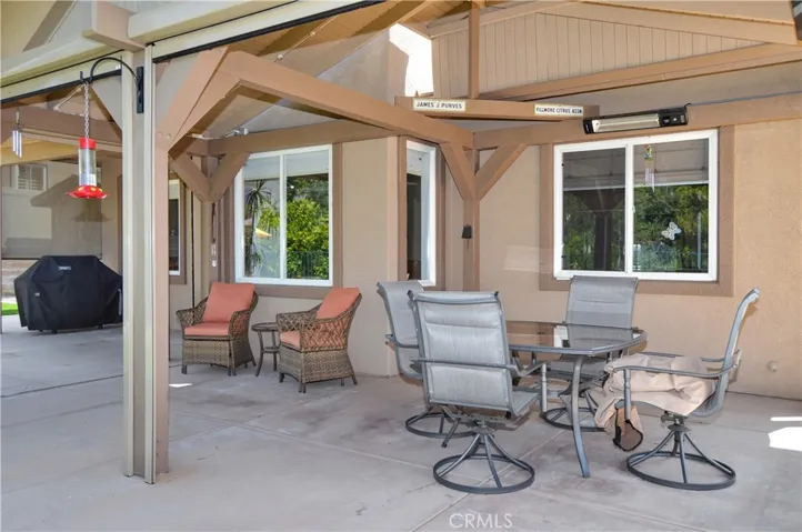 Covered Patio Retreat with the Privacy Shades Open. The TV, Heater, and Lights are Included to Combine the Best of Indoor/Outdoor Living while Enjoying Your Amazing Backyard