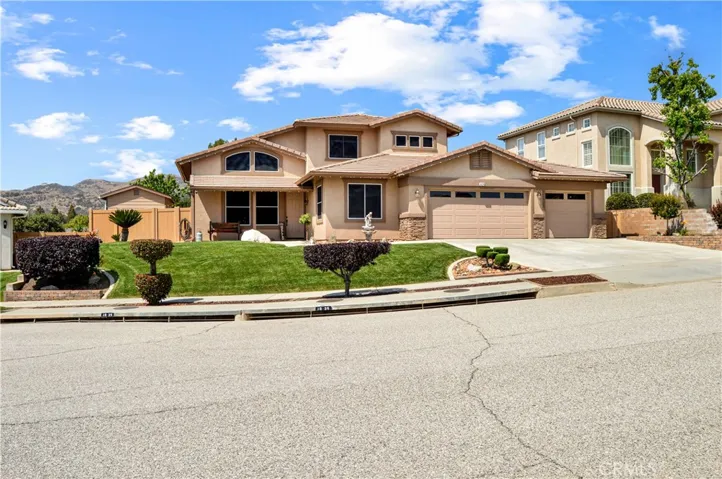 Back to the front to take note of the manicured lawn and shrubbery, vinyl fencing, 3-car garage and energy-efficient solar shade screens on the windows of this meticulously-maintained one-owner home.