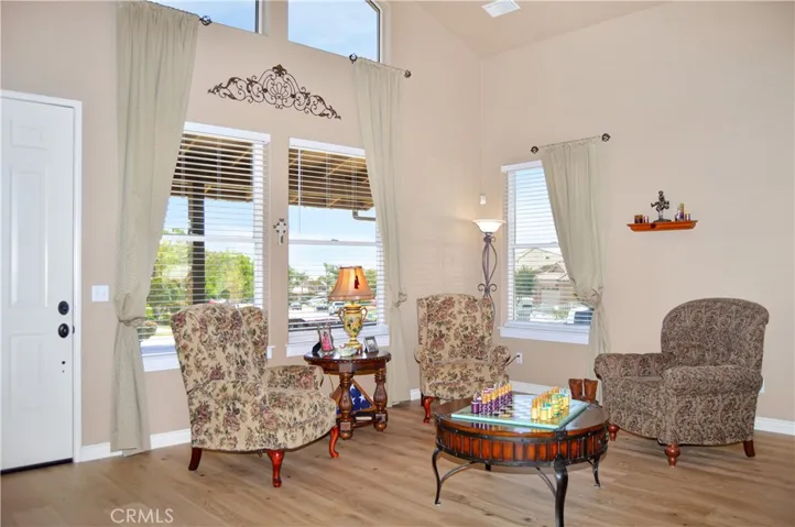Elegant Living Room at Entry with Dramatic Double-Height Ceilings with New Engineered Hardwood Flooring