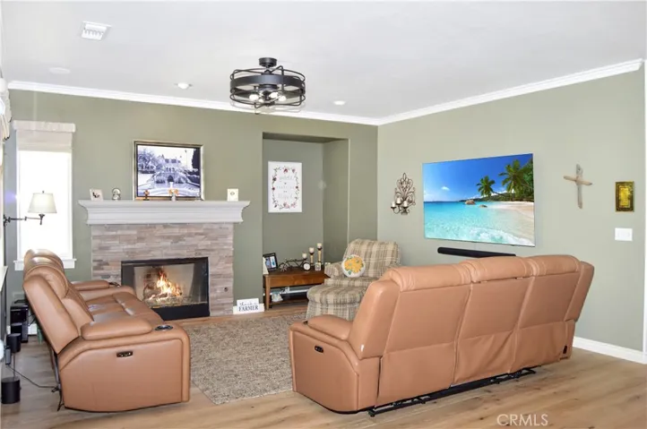 The Family Room with Cozy Fireplace is Open to the Kitchen and Nook and Shares those Tree-Filled Views. The Glass Door has Integrated Blinds and a Phantom Screen Allows the Cool Breezes in when Desired. (Fire and screen images are simulated)
