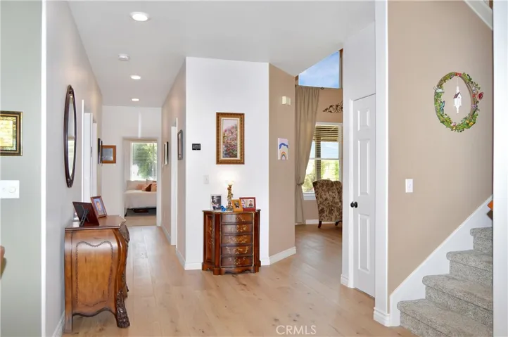 Down the Main Floor Hall, the 4th Bedroom with a Walk-in Closet is at the End. The 3rd Full Bathroom with a Shower/Tub Combo is on the Right. The 5th Bedroom (no closet), Laundry Room, and 3-Car Garage are on the Left. We'll head upstairs, then come back to those. Yes, there's a large wraparound closet under the stairs.