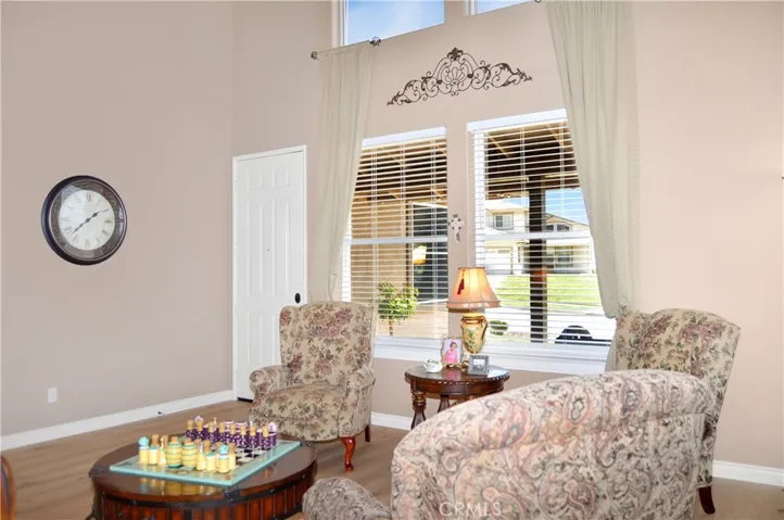 Elegant Living Room at Entry with Dramatic Double-Height Ceilings with New Engineered Hardwood Flooring