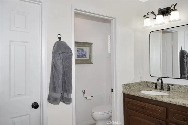 The Main Suite's Bath Boasts Incredible Views, Separate Tub and Shower, Dual Sinks, a Private Toilet Room, and a Walk-in Closet. It has Been Updated with an Extended Shower Enclosure, Granite Countertops, Modern Fixtures and Lighting.