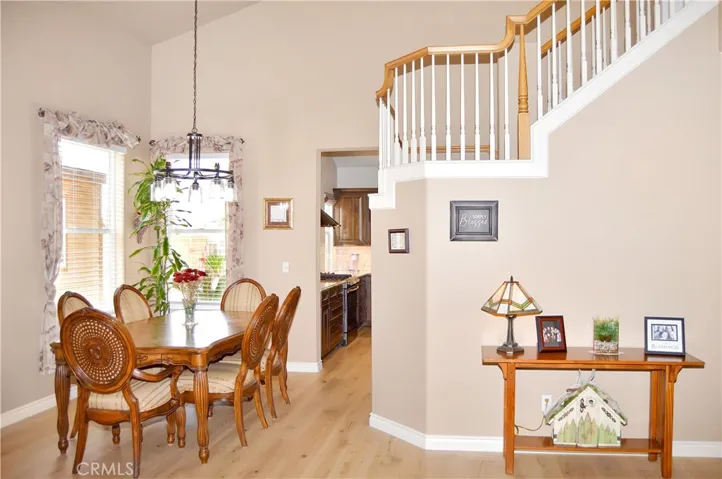 The Dining Room has a Modern Chandelier and Flows through to the Remodeled Kitchen Beyond