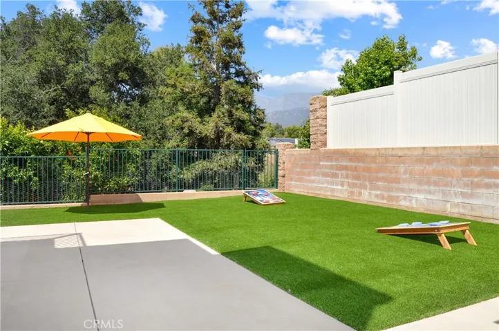 More Low-Maintenance Space to Enjoy on this Side of the Yard. Cornhole Anyone? Delicious Navel Oranges Grow Right Outside the Fence (Yes, there's a gate to access that part of your yard).
