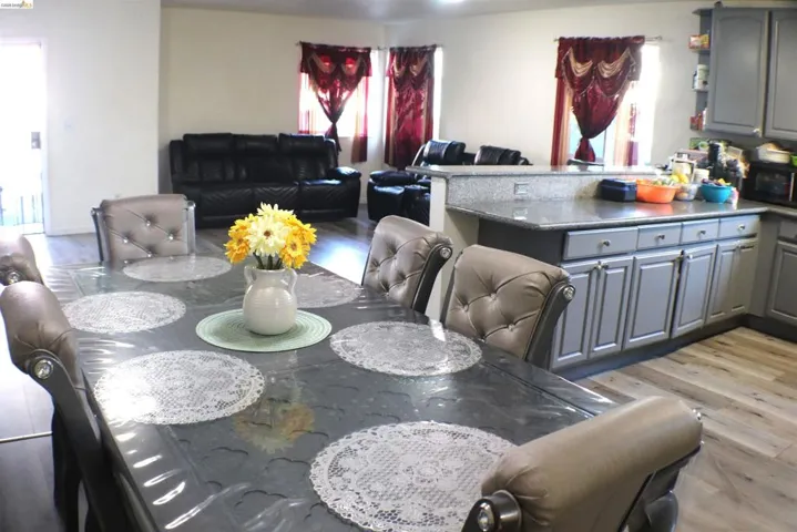Open-concept living space featuring wood-finish flooring