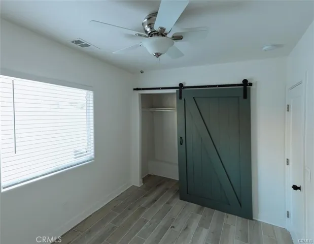 Bedroom with a  Barn Door Closet